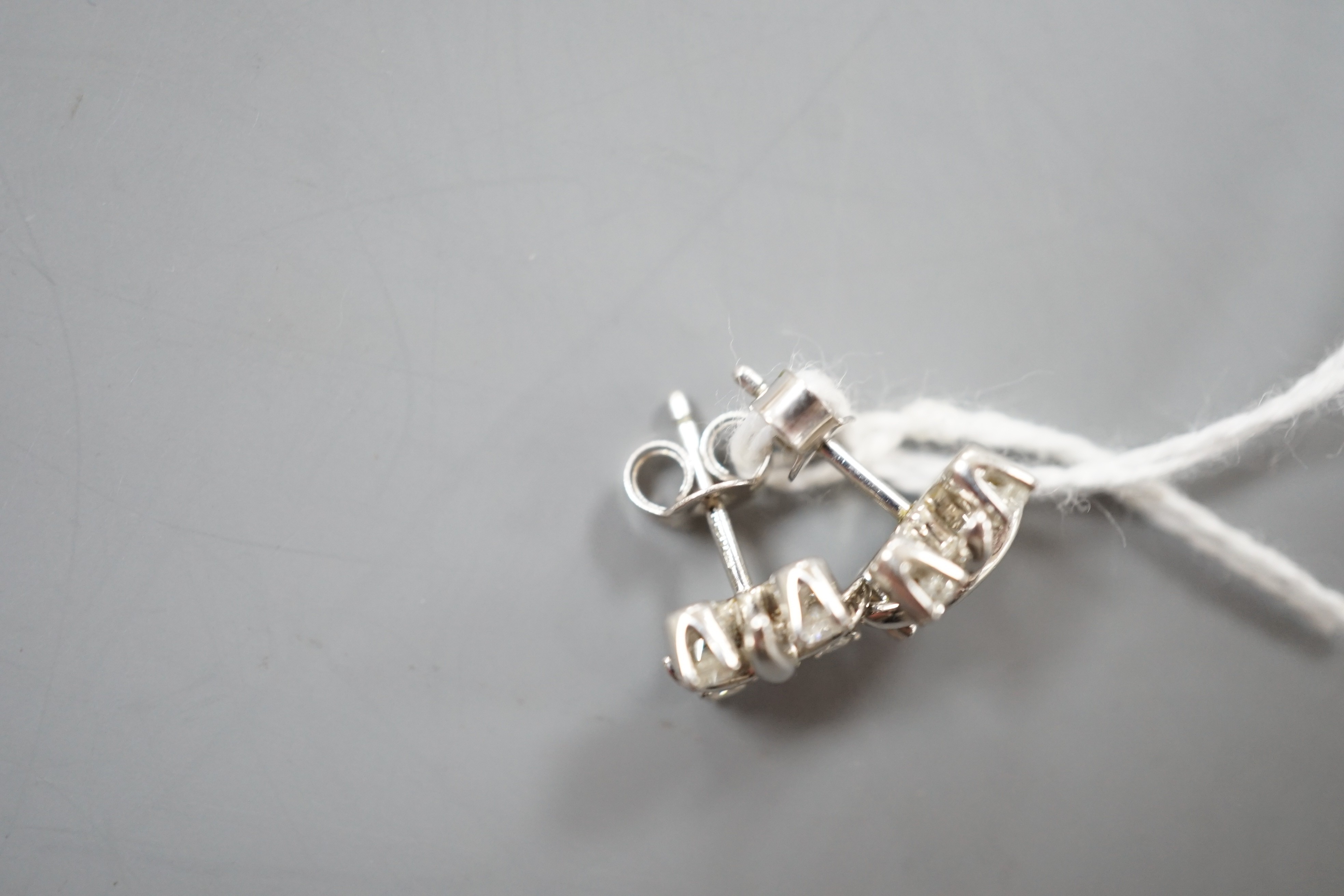 A modern pair of Tiffany & Co platinum and four stone diamond set square cluster ear studs, 7mm, gross weight 3.9 grams, (associated butterflies).